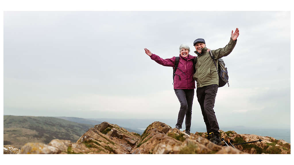 A Couple holding hands on a mountain 