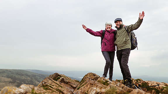 A couple standing on a mountain
