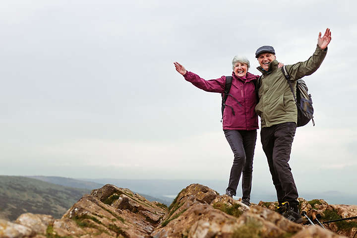 A couple standing on a mountain