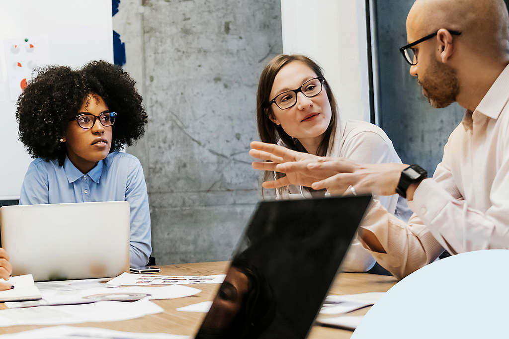 Three coworkers meeting in conference room