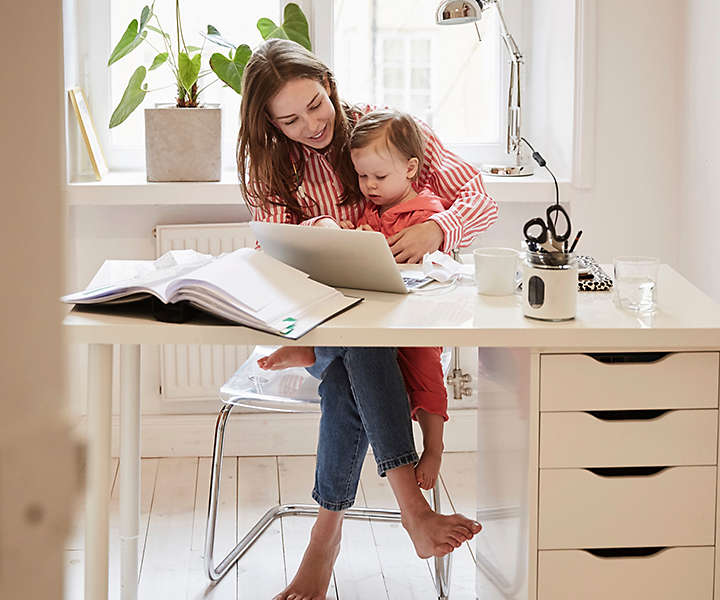 Woman working at desk with child