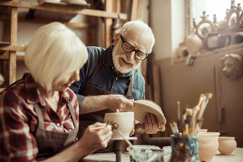 Older couple enjoying pottery