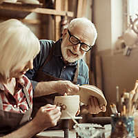 Older couple enjoying pottery