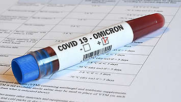  A test tube thats label reads Covid 19   Omicron