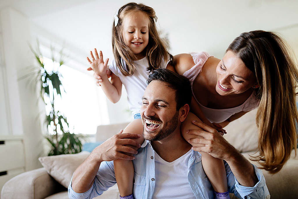 Parents with daughter playing.