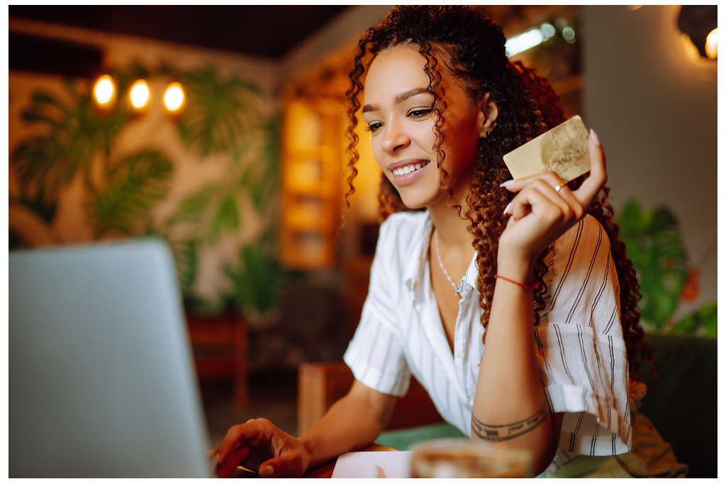 young woman shopping online with a credit card