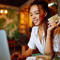 young woman shopping online with credit card