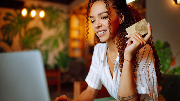 A woman browsing the internet on a laptop