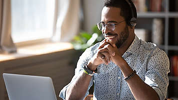 man working on policy over zoom