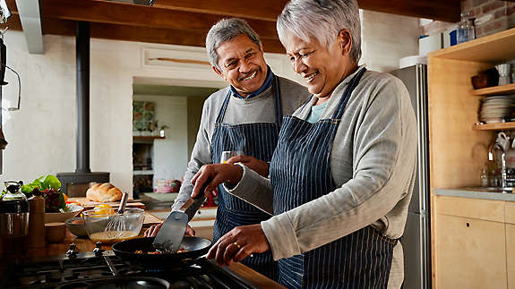 A couple cooking in the kitchen