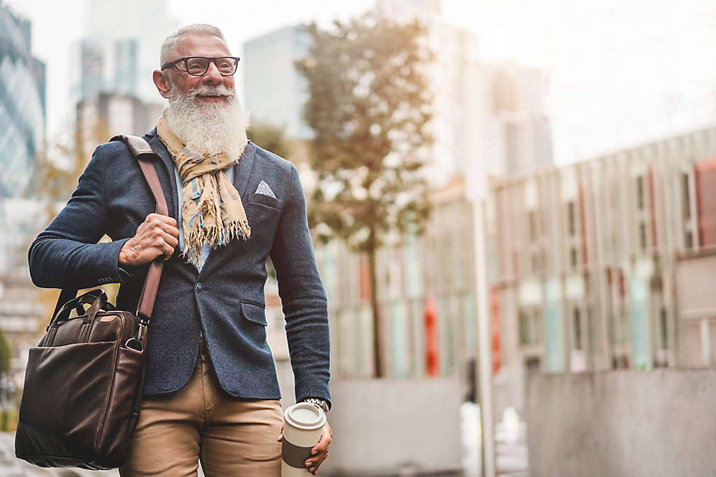  A mature person walking on the street smiling