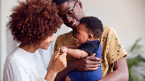 Young family holding baby