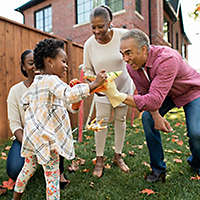 Grandparents spending time with their daughter and granddaughter