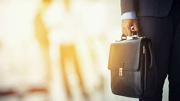 A person holding a suitcase