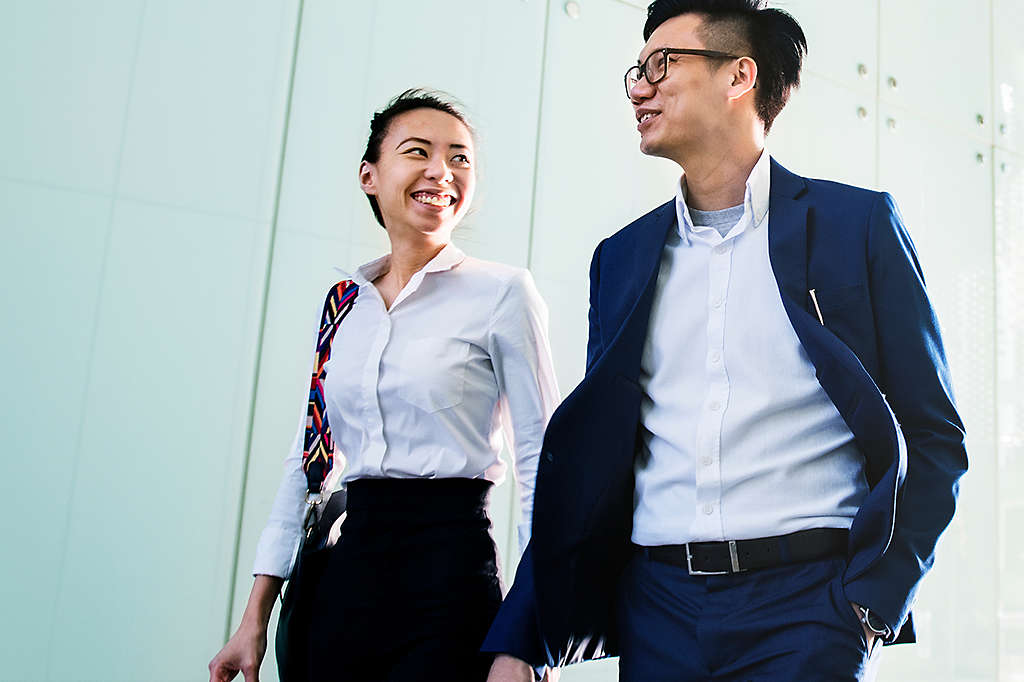 Two employees walking in professional attire