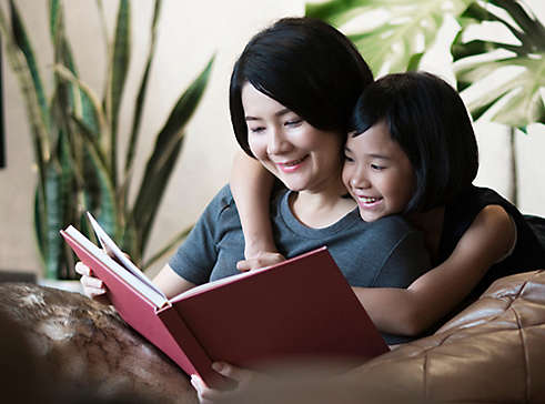 Mother reading to her daughter