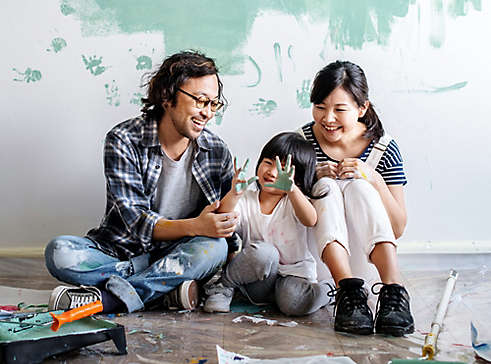 Two people painting with child