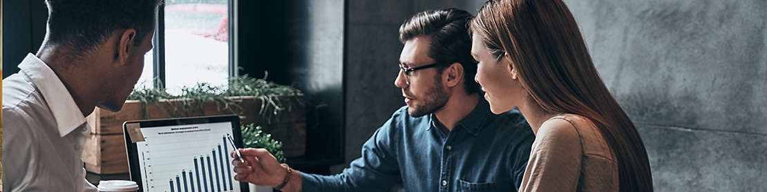 People discussing graphs on a computer