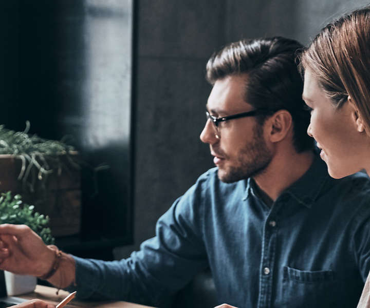 People discussing graphs on a computer