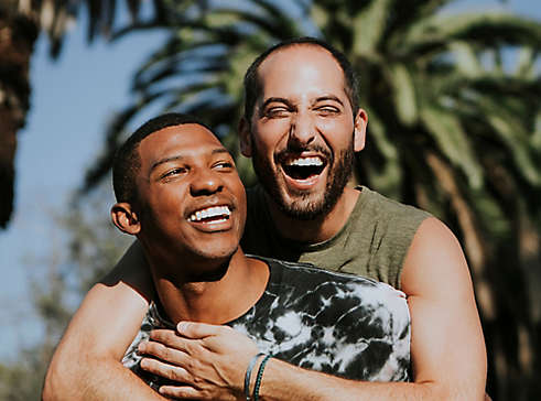 Couple embracing each other and smiling.