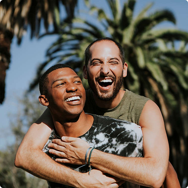 Couple embracing each other and smiling.