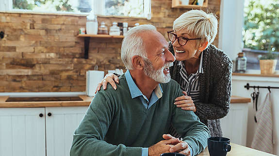 Elderly couple talking in kitchen