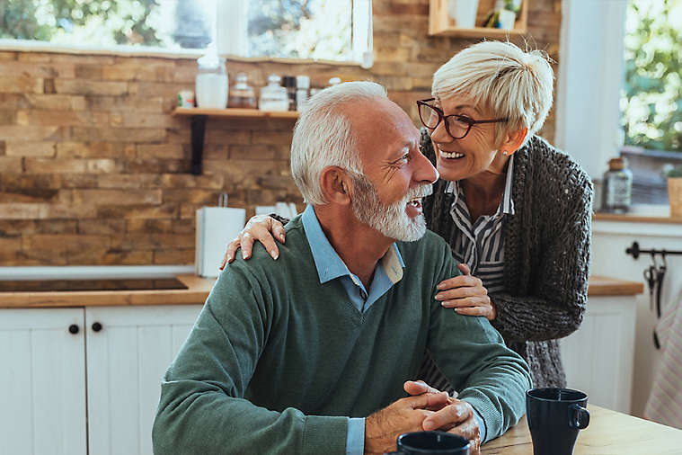 Elderly couple talking in kitchen