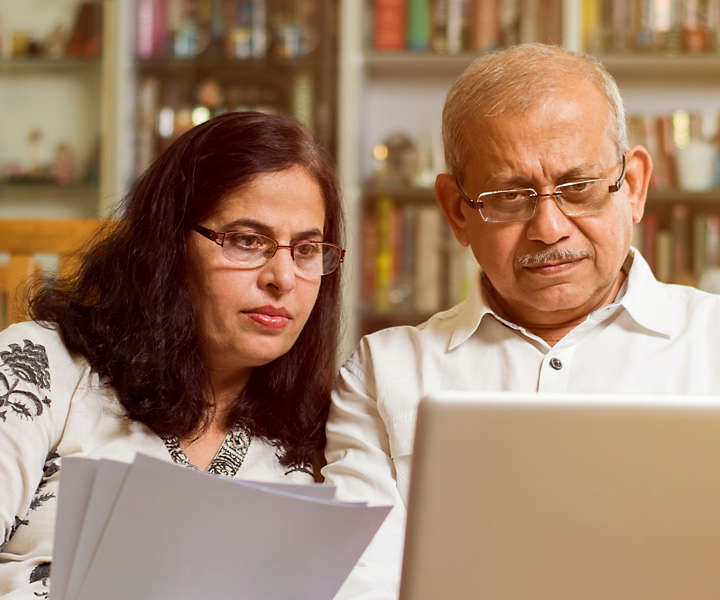 Two people discussing notes on computer