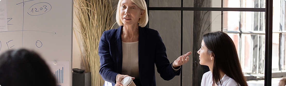 Woman presenting to a group of financial professionals