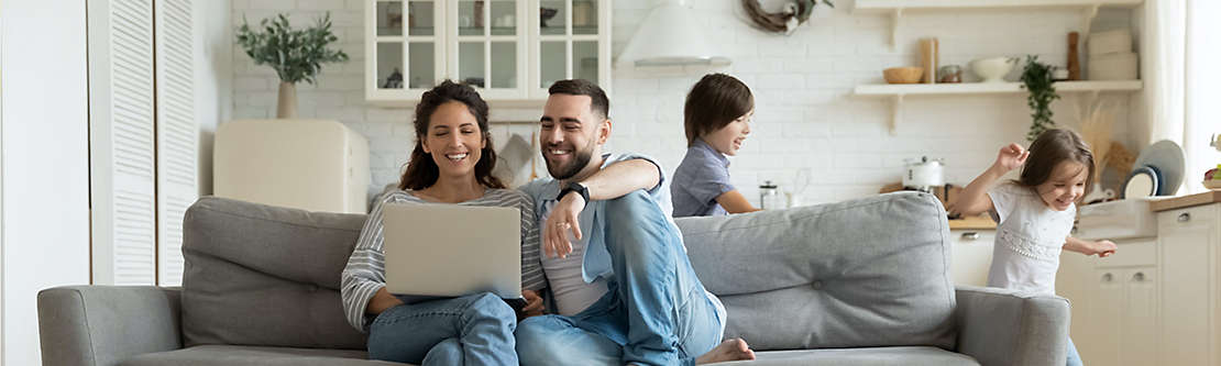 People using computer on couch