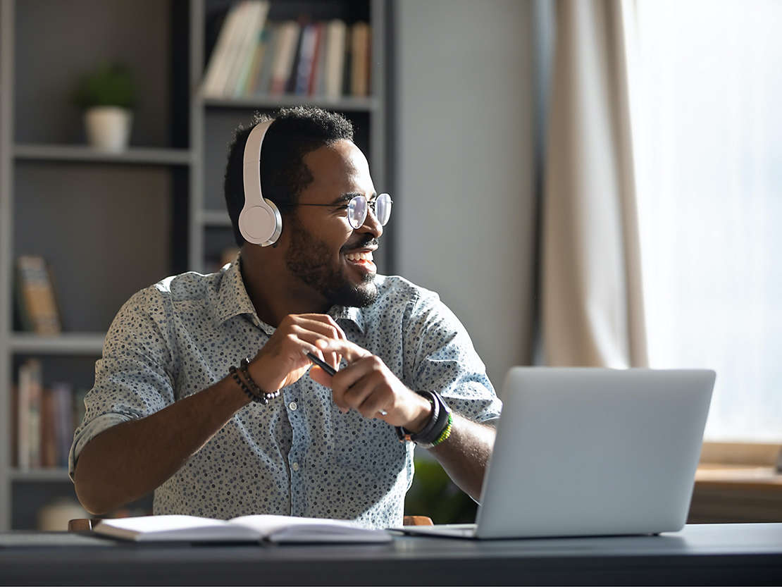 Man on laptop with headphones