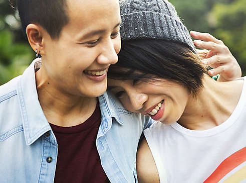 Two people holding each other and smiling