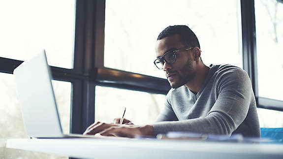 A man at a desk working on a computer.