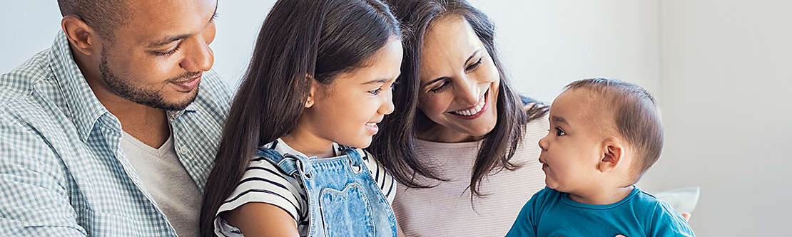 Family hugging new born