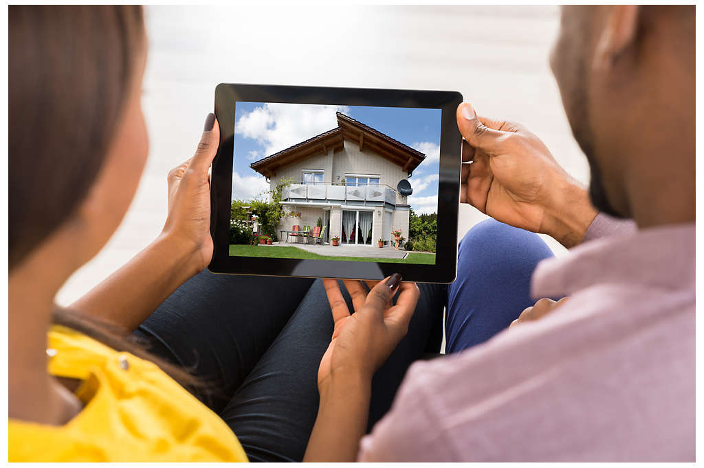 A couple browsing for houses on an ipad