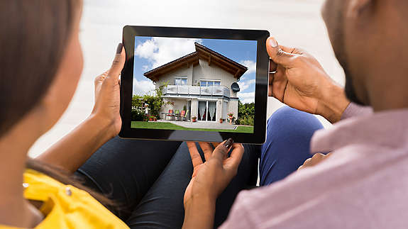 A couple looking at houses on an ipad