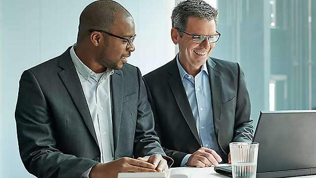 Two businessmen looking at a laptop