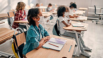 Children in classroom wearing masks