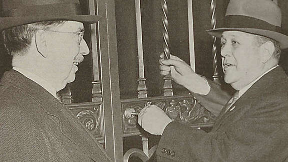 Company President George L. Harrison turned the key in the Madison Avenue gate to open the Home Office for New York Life's 100th year of business.