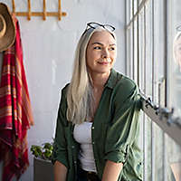 Middle aged woman sitting in her sunroom