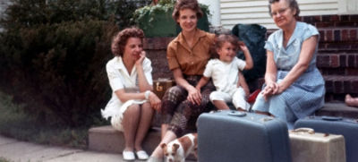 3 generations of women sitting outside on porch stairs. 