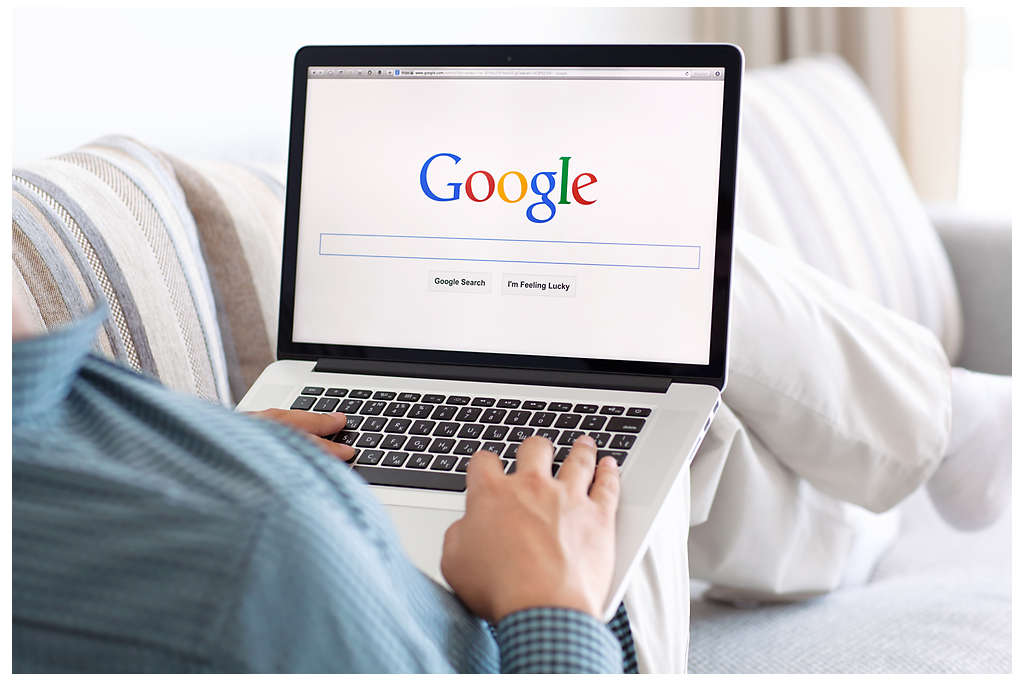 A person browsing the Google search engine on their laptop