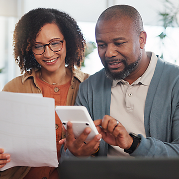 A couple using a calculator for their finances.