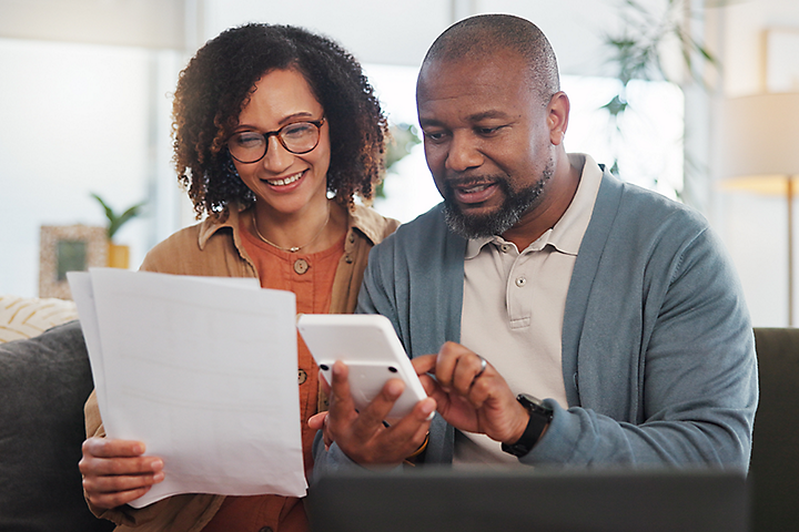 A couple using a calculator for their finances.