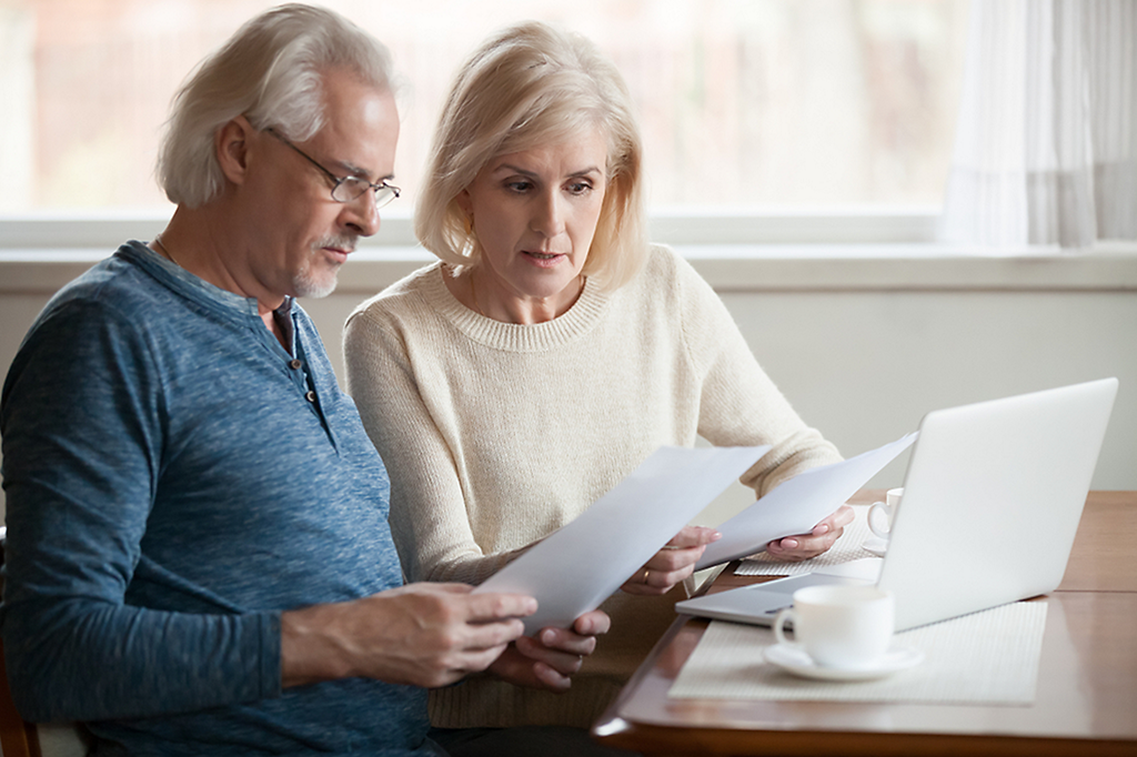 Elderly couple reviewing their finances