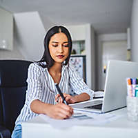 woman-writing-at-desk-1x1