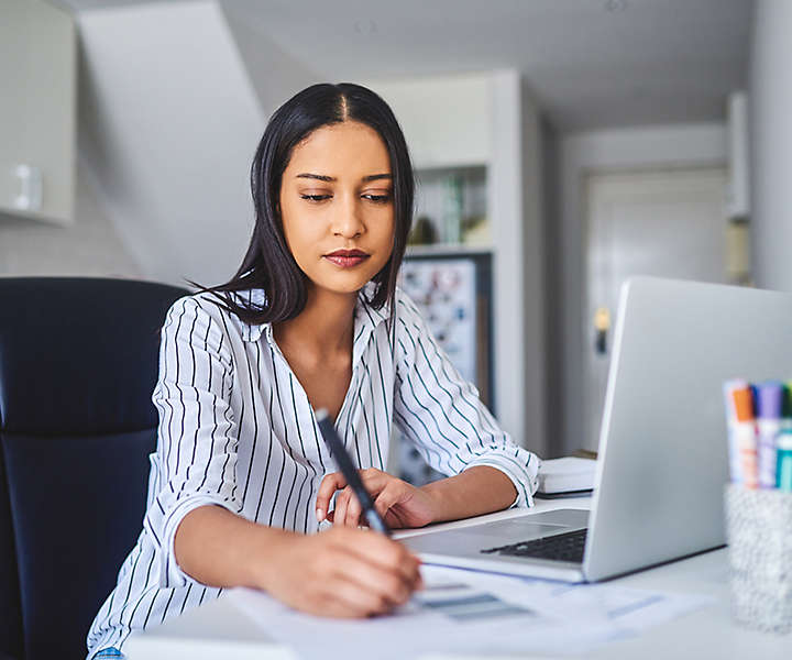 Woman writing at desk