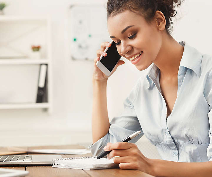 Women talking on the phone doing finances