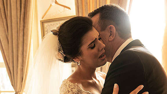 A newly married couple embracing each other.