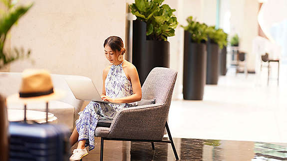 woman sitting and researching insurance on her laptop
